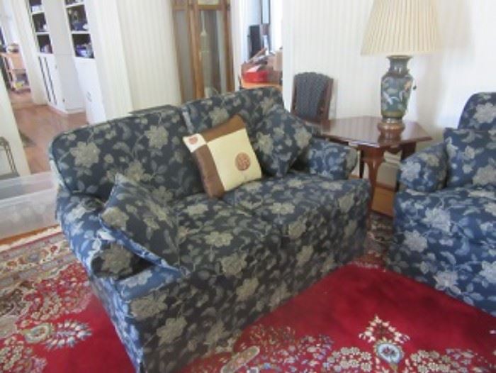The upholstered loveseat has 2 cushions and 2 pillow. The upholstered couch also has 3 cushions and 2 pillows. 