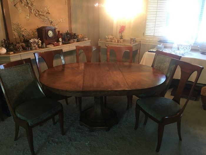Dining table by Mastercraft Furniture Co. with Watertown slides.  Approx. 50" in diameter without any leaves.  Comes with 4 leaves that are 20" so table expands various lengths to 130".  Includes table pads.