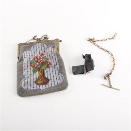 Vintage Beaded Purse: A vintage beaded purse. The purse has a gold tone chain handle and a floral frame. The body features multicolored seed beads threaded into a flowers in vase design. The interior is lined with a brown fabric. No visible maker’s mark.