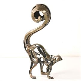John D. Jagger 1992 Limited Edition Bronze Sculpture "Lemur": A 1992 limited edition Modernist bronze sculpture by listed California artist John D. Jagger titled Lemur. The piece depicts an openwork metal lemur, shown crouched on all four legs with its long tail curled and raised in the air. The sculpture includes textured details throughout to suggest the presence of fur. The work is signed “Jagger ’92” in the mold to one of the figure’s rear legs, where it is additionally numbered out of an edition of 100. More information about the artist can be found by visiting the link in Additional Information below.