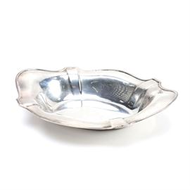 1913 Gorham Sterling Silver Tray: A sterling silver tray by Gorham. This piece features an oval shape with a scalloped edge. The underside is stamped with the Gorham hallmarks above “Sterling A5494”. The tray is also stamped with a clover symbol, which dates this piece to 1913. The approximate weight is 11.245 ozt.