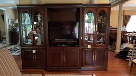 Entertainment center and separate lighted curio cabinets.