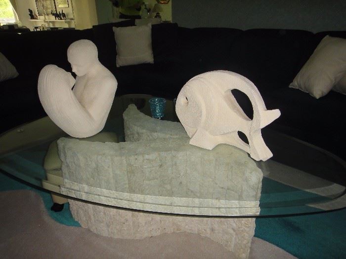 Contemporary Glass and sculpted base coffee table. Ceramic figurines.  