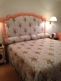 King bed with custom bedding and padded headboard