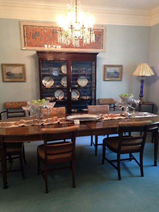 Fine dining table with 8 chairs; antique breakfront; framed silk panel