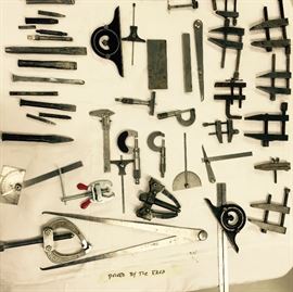 Assortment of chisels, micrometers, and other small precision tools