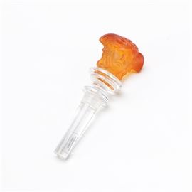 Rosenthal Amber "Medusa" Crystal Wine Stopper: A Rosenthal _ Medusa_ crystal wine stopper. Featured is a 24% lead crystal wine bottle stopper with a frosted amber tone depiction of Medusa finial. The piece is marked with “Rosenthal Versace” and includes original box packaging.