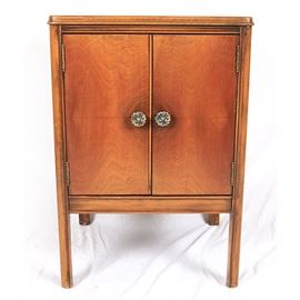 Vintage Cabinet: A vintage cabinet. This square top cabinet with beveled edge features two cabinet doors with decorative knob handles opening to a storage shelf rising on marlborough legs. This piece is marked “Sun Clow”.