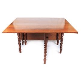 William and Mary Inspired Gate Leg Table: A William and Mary inspired gate leg table. This drop leaf table features a rectangular top rising on turned legs terminating on tapered feet. There are no visible maker’s marks.