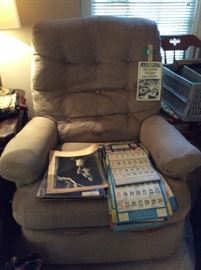Elvis items & old St Joseph calendars in La-z-boy recliner