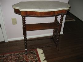 Walnut table with marble top.