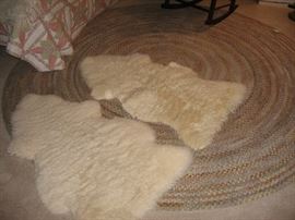 Chenille braided rug. Two sheepskin rugs.