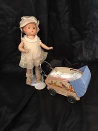 Antique doll with vintage baby buggy 