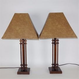 Contemporary Arhaus Matching Table Lamps: A pair of matching Contemporary table lamps from Arhaus, featuring a copper tone metal column style body with a square base, single socket construction, and tapered square faux leather shades. Each lamp is 30" tall.