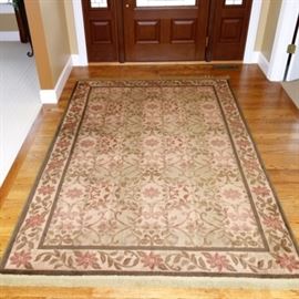 Mohawk Home Accent Rug: A Mohawk Home accent rug with a cream color field and covered with a floral and leaf motif. This machine made rug is 100% olefin and is fringed on either end.
