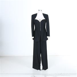 Kathryn Dianos Set with Beaded Trim: A Kathryn Dianos set with beaded trim. This set features a navy blue jacket with a sweetheart neckline lined in a white beaded material, white rhinestone buttons, and white beaded trim around the bottom of the sleeves. This set also includes a pair of loose fitting dress pants.