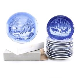 Annual Decorative Plates With Royal Copenhagen: A collection of porcelain annual decorative plates. There are twelve plates included in a variety of patterns and styles with different themes. Several plates are marked to the back including “Royal Copenhagen”.
