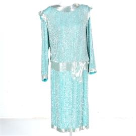 Vintage Silk Beaded and Sequined Evening Dress: A vintage silk beaded and sequined evening dress. This seafoam colored, Indian-made dress falls beneath the knee. It has long sleeves and wide bands of beaded trim, featuring vertical rows of sequines on arms, top, and skirt, with a semi-exposed back. It is tagged in the interior.