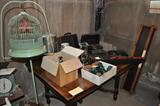 Another oak table, glass insulators, several old typewriters