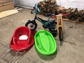 Trek Kids Bike with Training Wheels, Skuut Wooden Balance Bike, and Sleds.