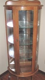 Oak curved glass curio cabinet. Lighted.
