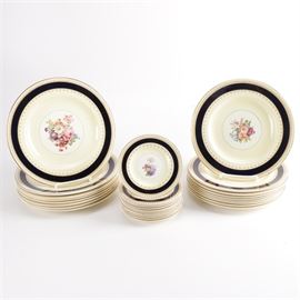 Wood & Sons "Sherborne" China Tableware: A Wood & Sons Sherborne china tableware set. This china set includes twenty-eight pieces with a gilded black border and a central floral bouquet emblem. The pieces are marked to the underside.