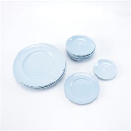 Assorted "Greydawn" Johnson Brothers China Pieces: An assortment of china in the Greydawn design from Johnson Brothers. This selection includes dinner plates, saucers with slightly curved rims, and a single bread and butter plate. The pieces are in a light blue and have indented edges, marked “Greydawn Johnson Bros Made in England” to their undersides.