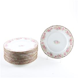 Higgins & Seiter China plates: A set of china plates by Higgins & Seiter. This set features eleven scallop edged plates with gilt trim decorated with a pink floral pattern around edge and center of the plate. The underside of each plate is stamped with the Higgins & Seiter mark.