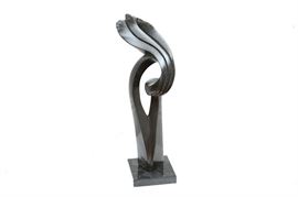 Muteta Abstract Shona Stone Sculpture On Marble Stand: A hand carved Zimbabwean Shona stone sculpture by Lincon Mutera (b. 1975). This sculpture is carved from a black serpentine stone and depicts an abstract form with curved features to the top. The artists signature can be found the backside.