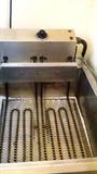 7 ft long deep fryer with stainless steel counter attached and storage space underneath counter. See next picture.