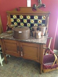 Antique washstand; to the right, one of several  Longaberger baskets