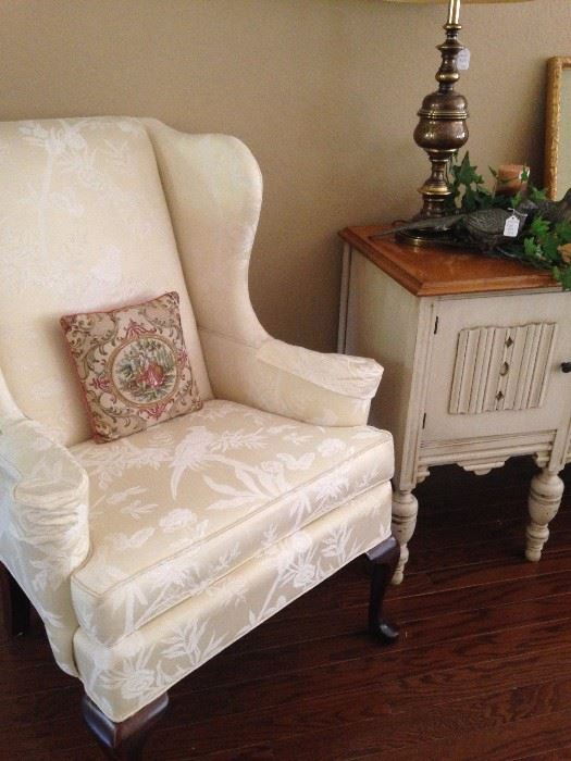 One of two Queen Anne style wingback chairs; small Shabby Chic side table