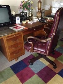 One of two large desks and office chairs