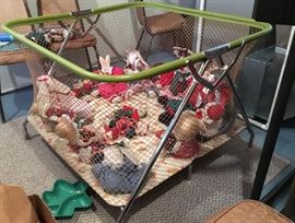 Playpen filled with collectible holiday and other dolls