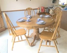 Round oak table, 4 chairs and very wide leaf, will go out to 72" wide.