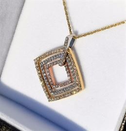 Tri-Colored Gold Movable Pendant with Pave Set Diamonds - 8.1 grams 14 kt. yellow gold, approximate total diamond weight 1 1/2  kt (conservative estimate) SI-2 Clarity H Color - 18 inch yellow 14 kt. gold chain...absolutely spectacular.