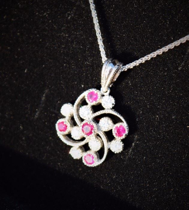 5 "A" Quality Round Rubies and 8 Round Brilliant Cut Diamonds Prong Set in a Floral Motif - 1/2 Total kt wt SI-2 Clarity H Color, 18 inch 14 kt white gold chain...absolutely lovely