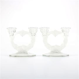 Glass Candelabra Pair with Bowl: A pair of glass candelabras with a matching bowl. These pieces feature circular columns made of frosted glass in the form of grape vines and are each adorned with a pair of hive shape candle holders. The matching bowl features scalloped edges with a frosted fruit motif along the base. There are no maker’s marks present.