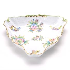 1992 Herend "Queen Victoria" Porcelain Bowl: A 1992 porcelain bowl in the Queen Victoria pattern by Herend. This triangular bowl features a gilded serpentine rim and is decorated in bright colors with flowers and butterflies. The piece is marked “Herend Hungary Handpainted 1191/VBO B92” to the underside. The Queen Victoria pattern is so named because the queen ordered a set of items in this pattern at the London World Exhibition in 1851.