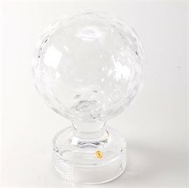 Tyrone Lead Crystal Golf Ball: A Tyrone lead crystal golf ball. This lead crystal golf ball from Tyrone features a dimple design and rests on a round base with a diamond cut pattern. The golf ball is marked on the side with a gold label.