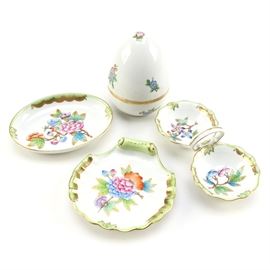 Herend "Queen Victoria" Serving China: A collection of serving china produced by Herend in the Queen Victoria green border design. This four piece set includes a decorative egg; a two piece relish dish with a finger loop handle; a shell dish; and a small oval shaped place. The pieces are painted with colorful floral designs and have gilt accents. Each piece is marked to its underside “Herend Hungary Handpainted”.