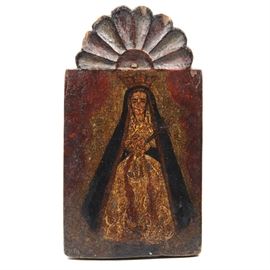 Excellent Retablo of Nuestra Señora de los Dolores: An excellent late 18th to early 19th Century Spanish Colonial retablo image on pine board, a fine depiction of Nuestra Señora de los Dolores (Our Lady of Sorrows). The image shows the Mary in a white dress and blue robe, a sword piercing her heart beneath clasped hands. She is wearing a crown and is surrounded by red drapes. This retablo has a carved floral aureole decoration above the image. The rustic painting is executed in black, red, blue and yellow on a rough hewn board.