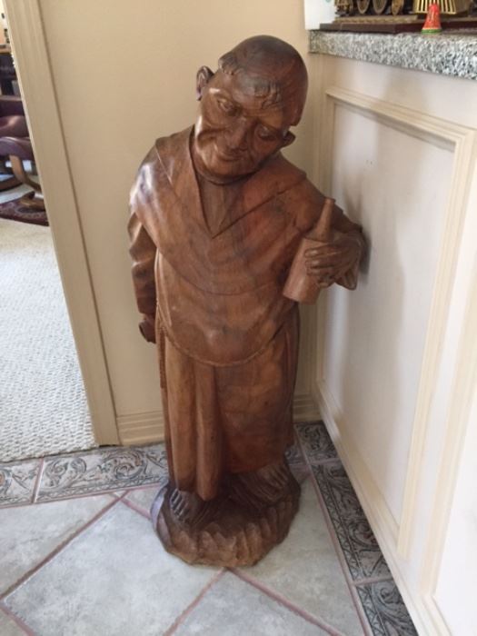 Wood carving of Monk with bottle of wine
