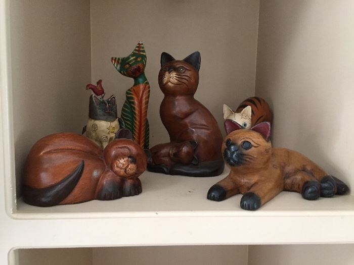 A collection of wood carving cats
