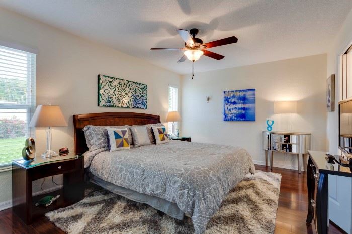 MASTER BEDROOM FEATURES BRAND NEW KING BEAUTYREST BY SIMMONS MATTRESS, TWO GLASS TOP SIDE TABLES, TWO BROYHILL CRYSTAL LAMPS, TWO MIRRORED ACCENT TABLES, MOSAIC ART WORK, SAMSUNG TELEVISION, 8X12 AREA RUG AND ARTWORK GALORE.