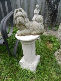 Antique column and concrete dog statue