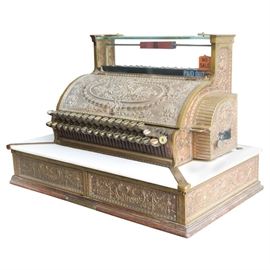 Antique Cash Register by The National Cash Register Company: An antique cash register by the National Cash Register Company. A paper tag on the bottom of the drawer states that this register is dated May 27, 1914 with the serial number 1414376. It was custom built for Deuthorn & Seider of Buffalo New York and sold by H. O. Whipple. The model # 359 features the “Dolphin” pattern on the brass metal cabinet, accented with wood base, marble shelf, and two spring rigged cash drawers.