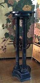 one of a pair of black marble pedestals