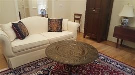 19th Century Embossed Brass disc - 36" round, India or Southeast Asia. Camel back sofa, custom fabric, off white.