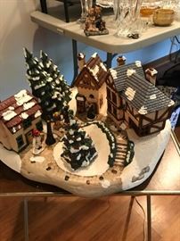 An adorable vintage Christmas village setting with ceramic trees and houses and people.